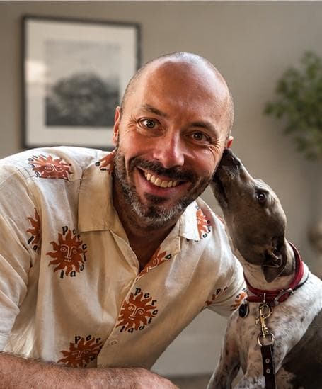 Leon Smith smiling with his dog Coco
